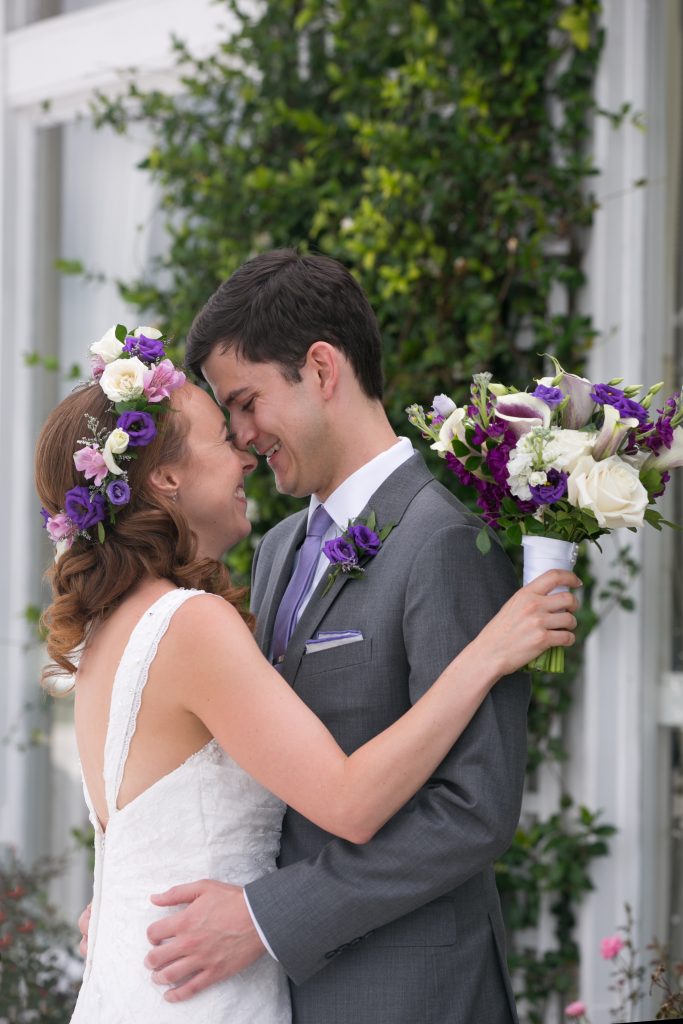 Flower crown and bridal bouquet in purple and white featuring lisianthus, roses and calla lillies.