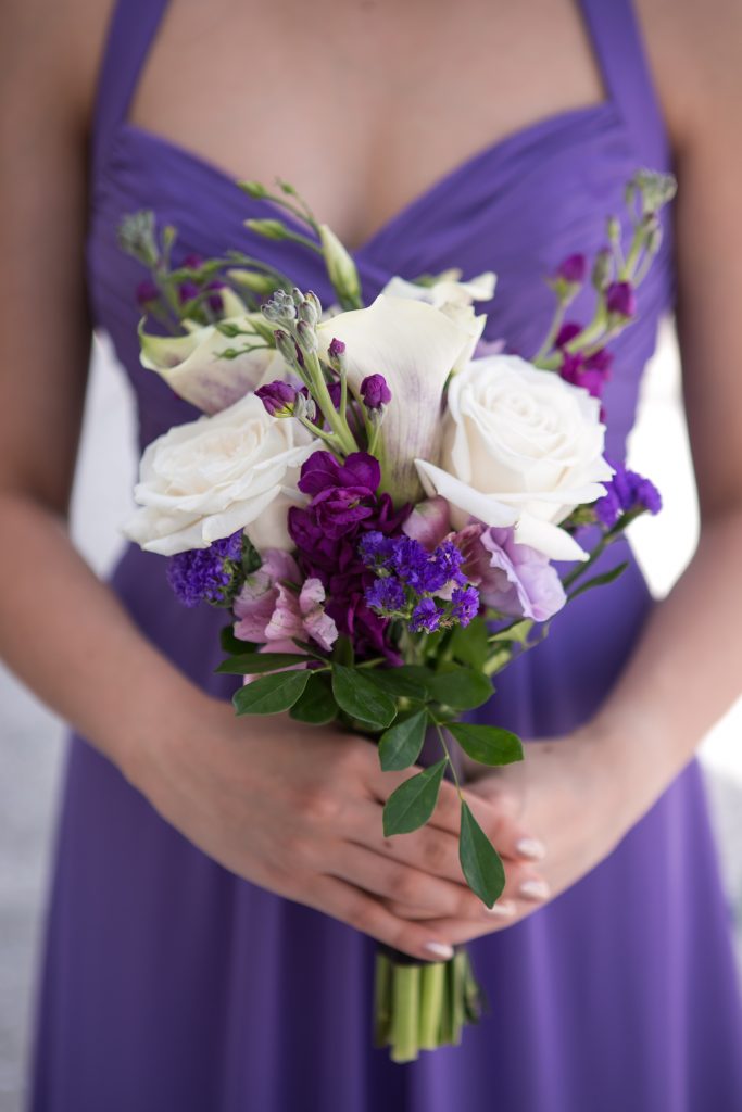 Nosegay bridesmaid's bouquet in purple and white with stock, statice, alstroemeria, calla lilies, lisianthus and garden roses.
