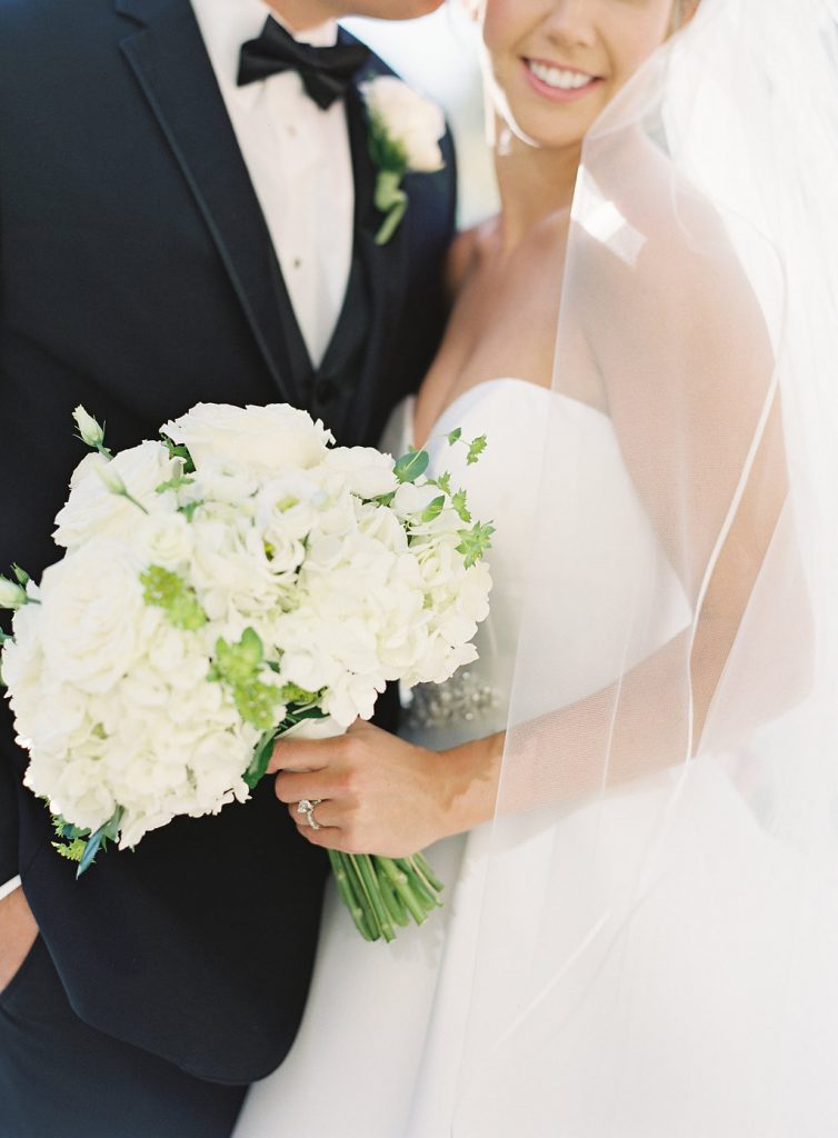 Classic bridal bouquet all white with hydrangeas, lisianthus, garden roses and bupleurum.