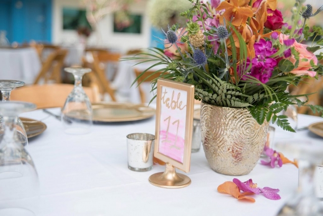 Tropical centerpiece in hot pink, orange, blue and green.