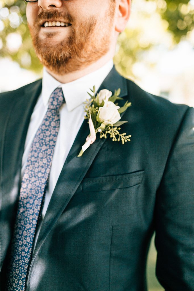 Classic white spray rose boutonniere with eucalyptus.