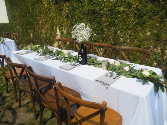 Rustic feast tables with garland and babies breath.