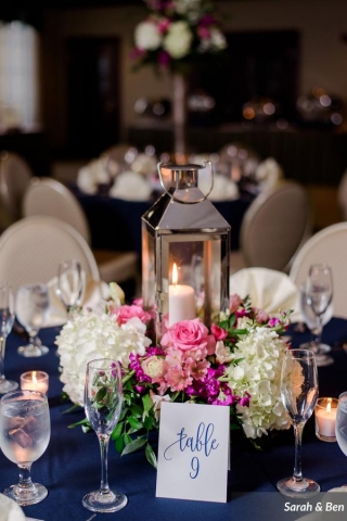 Silver lantern and fresh floral centerpiece in pink and white with roses, hydrangea and stock.