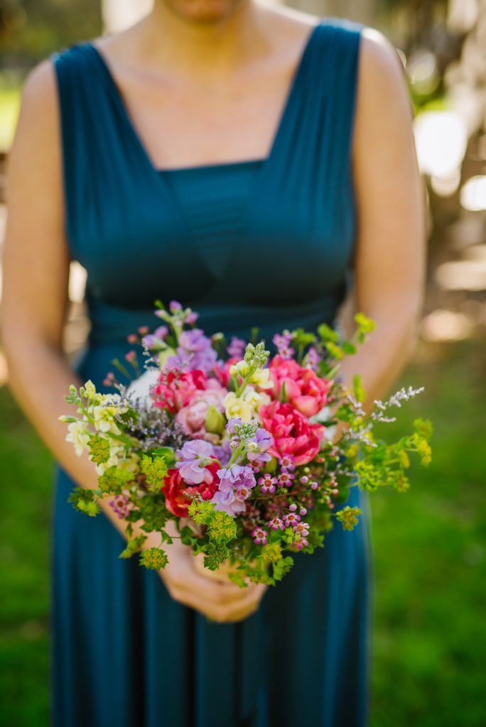 Garden style bridesmaid bouquet of wild flowers including stock, bupleurum, wax flower, tulips and caspia.