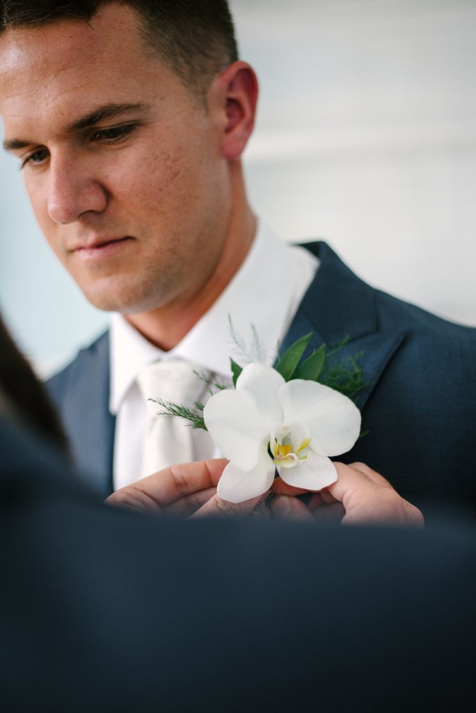 Groom boutonniere of white orchid.