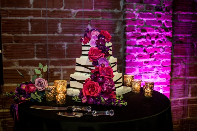 Modern fresh cake flowers in hot pink and purple of orchids and roses.