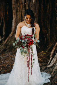 Organic red bridal bouquet with hanging amaranthus in St. Petersburg, Florida.