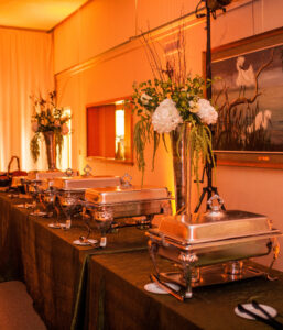 Organic style white flower and greenery buffet centerpieces for party.