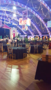 Modern elevated centerpieces on tables for fundraising gala.