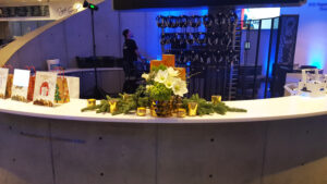 White and green arrangement with candlelight at corporate holiday event at Dali Museum.