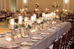 Romantic feasting table with white flowers and candlelight at the Vinoy Grand Ballroom in St. Petersburg, Florida.