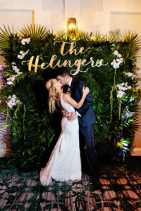 Tropical greenery and orchid photo backdrop at wedding reception at the Vinoy in St. Petersburg, Florida.