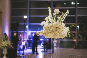 All white flower centerpiece elevated on clear glass at the Museum of Fine Arts in St. Petersburg, Florida.