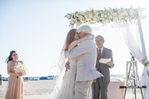 Classic white and blush flower header on arch for beach wedding ceremony in St. Petersburg, Florida.