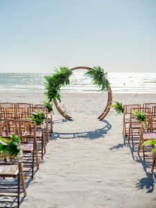 Moon gate and aisle pieces of tropical greenery for beach ceremony in St. Petersburg, Florida.