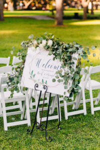 Organic greenery garland on welcome sign for wedding ceremony in St. Petersburg, Florida.