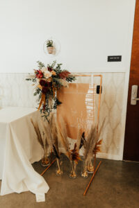 Boho and fall inspired welcome sign with flowers and pampas grass for wedding ceremony in Tampa, Florida.