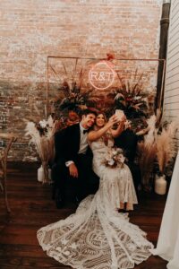 Boho fall inspired photo backdrop at wedding reception at Armature Works in Tampa, Florida.