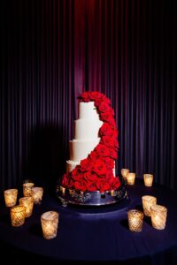 Dramatic red rose cascading cake flowers at wedding reception in St. Petersburg, Florida.