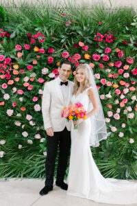 Bright pink flower and greenery backdrop at wedding reception at Museum of Fine Arts in St. Petersburg, Florida.