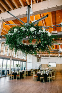 White flower and greenery floral chandelier at wedding reception at Tampa River Center in Tampa, Florida.