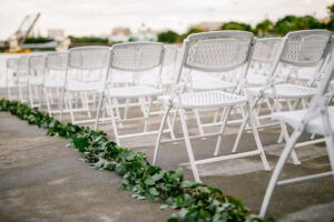Greenery garland lining the aisle for outdoor ceremony in Tampa, Florida.