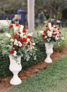 Red and white altar arrangement for outdoor wedding ceremony in Tampa, Florida.