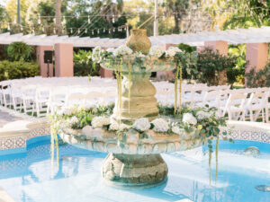Organic flowers decorating fountain for outdoor wedding ceremony at the Vinoy Tea Garden in St. Petersburg, Florida.