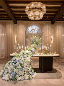 Grand waterfall entrance table arrangement with baby blue and white hydrangea at wedding reception at the Vinoy Grand Ballroom in St. Petersburg, Florida.