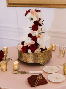 Romantic cascade of red, white and blush cake flowers at wedding reception in Tampa, Florida.