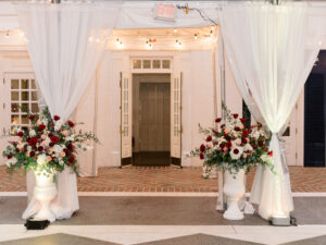 Red and white flower entrance arrangements for wedding reception at Tampa Yacht Club in Tampa, Florida.