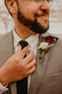 White spray rose and red calla lily groom's boutonniere in Tampa, Florida.