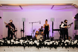 Classic white floral runner stage flowers at wedding reception at the Orlo House in Tampa, Florida.