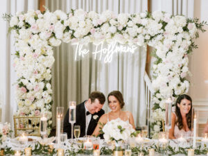 White and blush flower backdrop for head and sweetheart table at wedding reception at Vinoy Grand Ballroom in St. Petersburg, Florida.