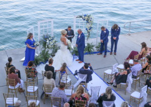 Altar of doors and white and blue flower arrangements for outdoor wedding ceremony in St. Petersburg, Florida.