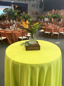 Tropical centerpiece on cigar box on cocktail table for school fundraising gala.
