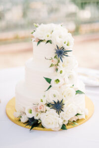Romantic cascading cake flowers of white flowers and thistle at wedding reception at the Vinoy in St. Petersburg, Florida.