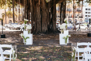 Modern white altar arrangements of calla lily, hydrangea and orchids for outdoor wedding ceremony at Museum of Fine Arts in St. Petersburg, Florida.