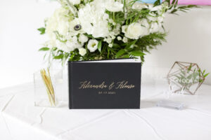 All white arrangement on welcome table to wedding reception at the Current Hotel in Tampa, Florida.
