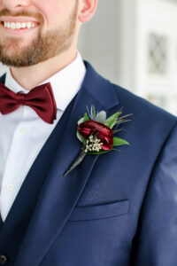 Merlot ranunculus and thistle boutonniere in Tampa, Florida.