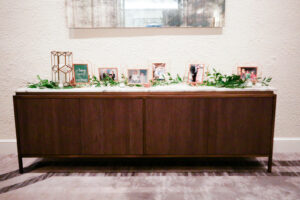 Modern greenery memory table at wedding reception in Vinoy Grand Ballroom in St. Petersburg, Florida.