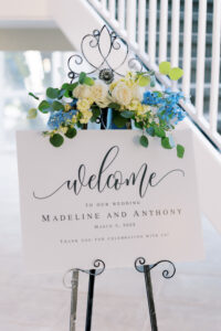 Pastel garden style flower piece on welcome sign at wedding reception at Isla del Sol in St. Petersburg, Florida.