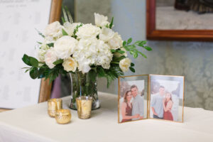 Classic white arrangement on welcome table at wedding reception at Museum of Fine Arts in St. Petersburg, Florida.