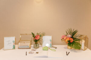 Tropical arrangements on welcome table at wedding reception at Sunken Gardens in St. Petersburg, Florida.