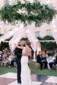Romantic floral chandelier with baby blue and white hydrangea and greenery above dance floor at wedding reception at the Vinoy in St. Petersburg, Florida.