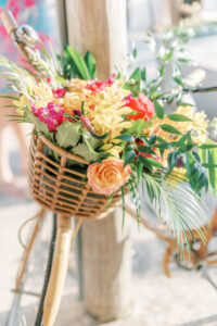 Tropical flower decor on bike at outdoor wedding at Post Card Inn in St. Petersburg, Florida.
