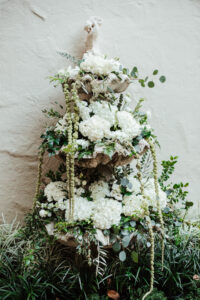 Fountain decorated with white hydrangea and hanging amaranthus for wedding ceremony at Museum of Fine Arts in St. Petersburg, Florida.