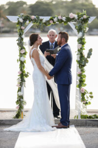 Simple garland on arch for outdoor wedding ceremony in Tampa, Florida.