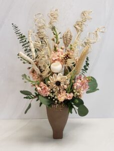A boho arrangement with dried keepsake blooms and fresh pink stock.